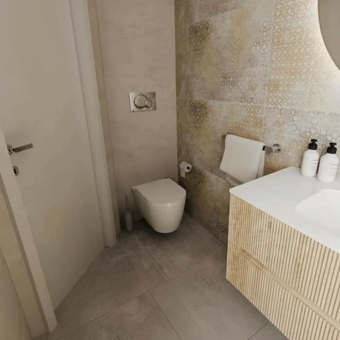 Salle de bains moderne avec lavabo intégré au plan de travail blanc, robinetterie dorée, miroir rectangulaire avec éclairage LED